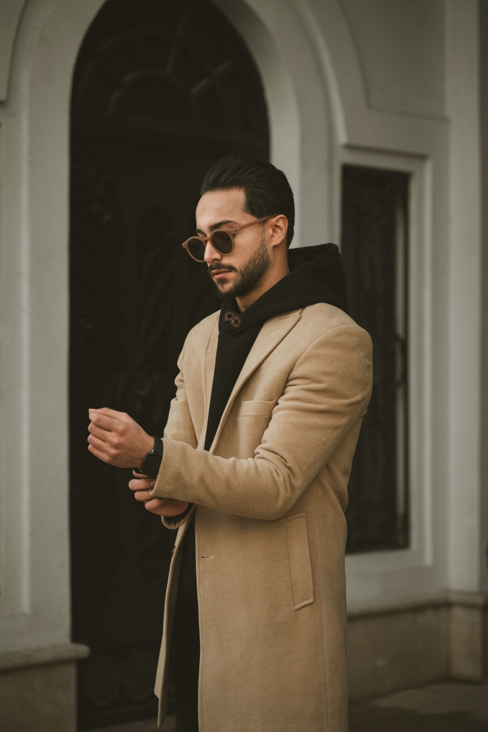 Stylish man in a brown coat and sunglasses in Lavasan, Tehran Province, Iran.